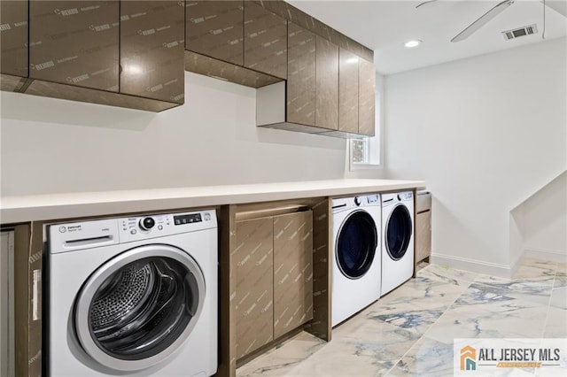 clothes washing area featuring washer and dryer, light marble finish floors, recessed lighting, baseboards, and cabinet space