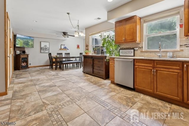 101 Pergola Ave, Monroe, NJ 08831 - kitchen featuring stainless steel dishwasher, ceiling fan, decorative backsplash, brown cabinets, and plenty of natural light