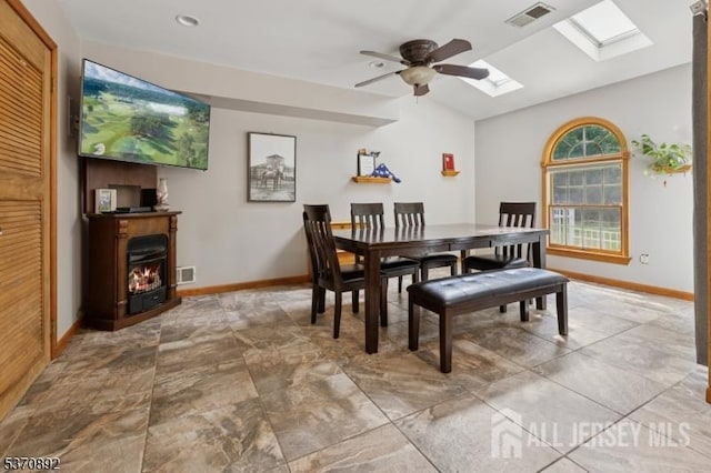 101 Pergola Ave, Monroe, NJ 08831 - dining space featuring a skylight, ceiling fan, a lit fireplace, and vaulted ceiling