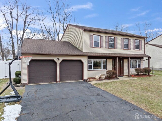 view of front of property featuring a front lawn and a garage