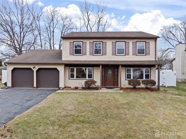 view of property with a front yard and a garage