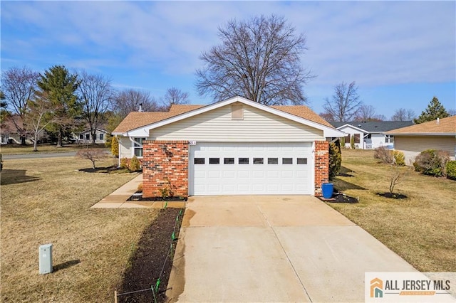 view of front of house featuring a front lawn, concrete driveway, and brick siding