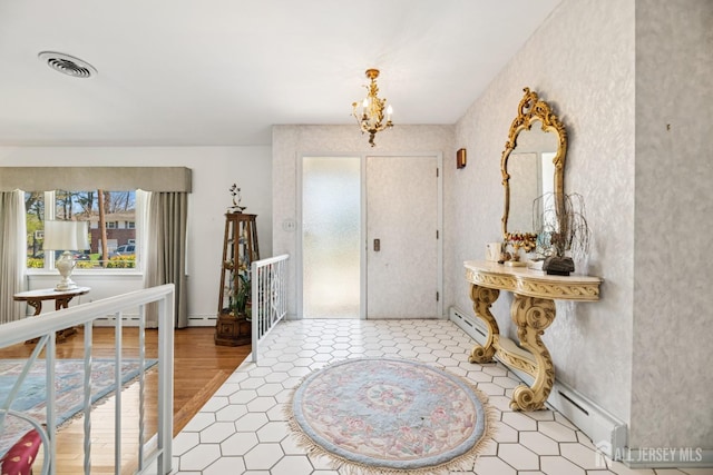 entrance foyer with a baseboard heating unit, a notable chandelier, visible vents, and a baseboard radiator