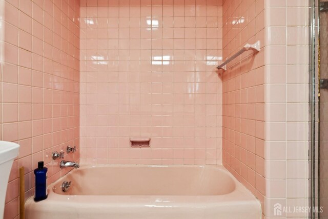 bathroom with a shower and a bathing tub