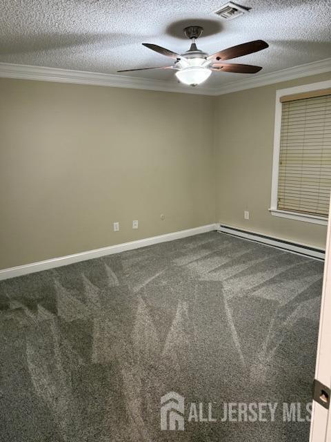 carpeted empty room with ceiling fan, a baseboard radiator, a textured ceiling, and ornamental molding