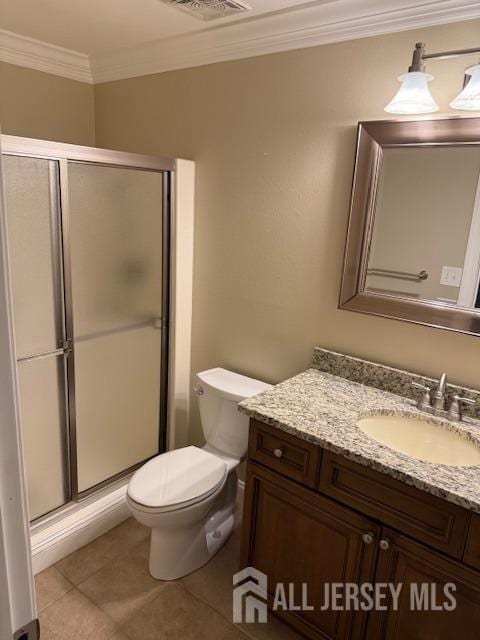 bathroom featuring ornamental molding, vanity, tile patterned flooring, toilet, and a shower with shower door