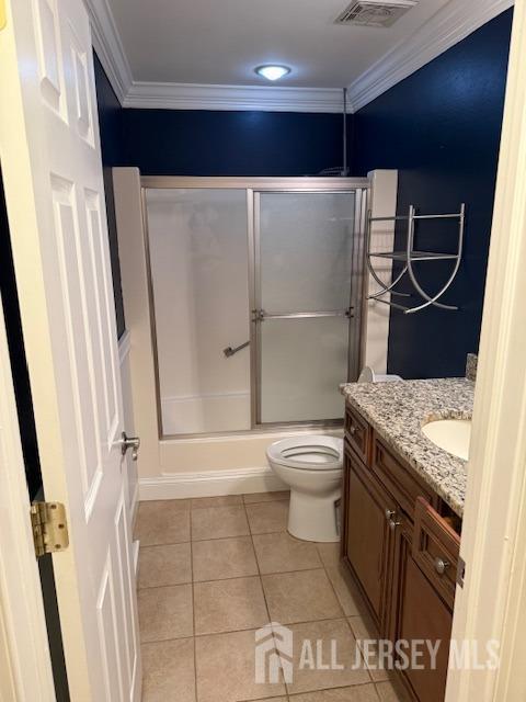 full bathroom featuring crown molding, tile patterned flooring, vanity, and toilet