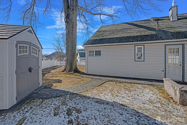 view of side of home featuring a storage unit