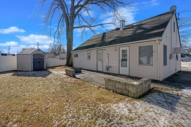 rear view of house featuring a yard and a shed