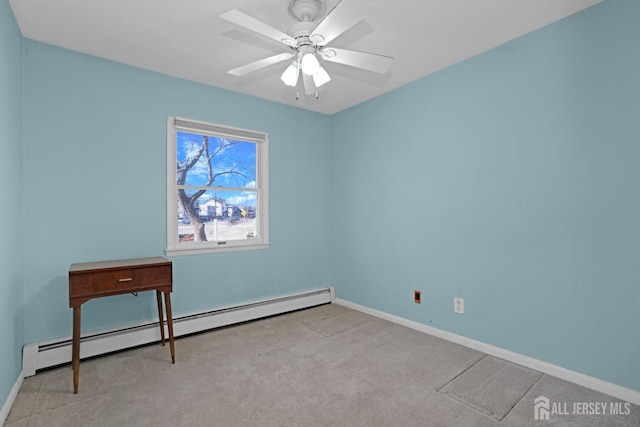 carpeted spare room with ceiling fan and a baseboard heating unit