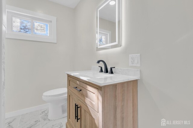 bathroom featuring vanity and toilet