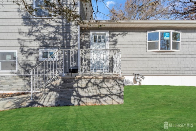 rear view of property featuring a lawn