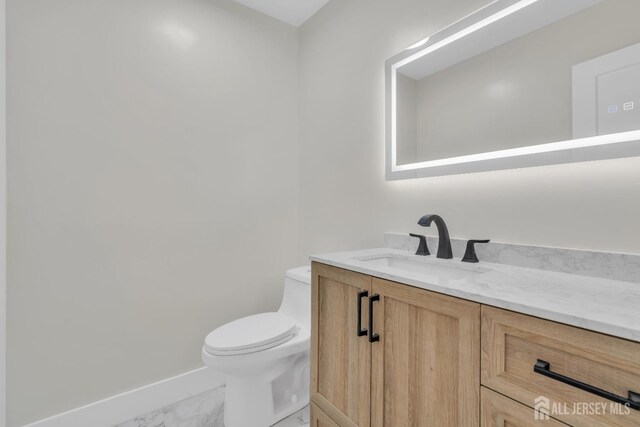 bathroom featuring vanity and toilet