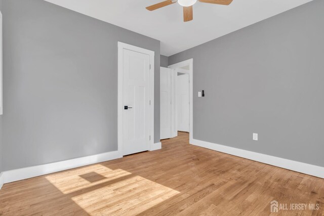 spare room with ceiling fan and light hardwood / wood-style floors