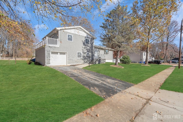 view of front property featuring a front yard, a balcony, and a garage