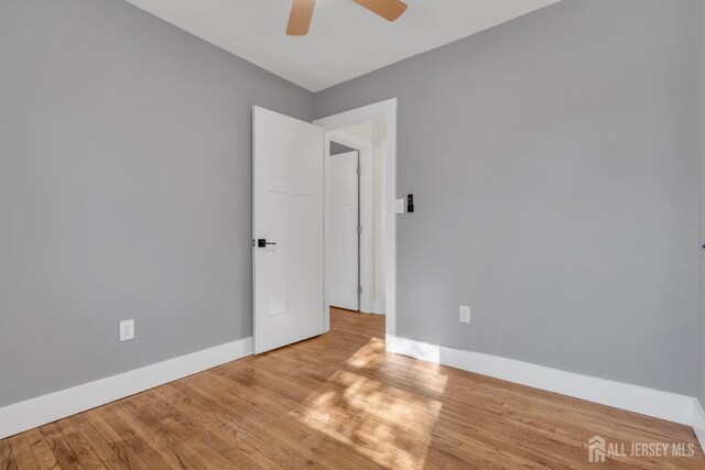 spare room with ceiling fan and light hardwood / wood-style floors