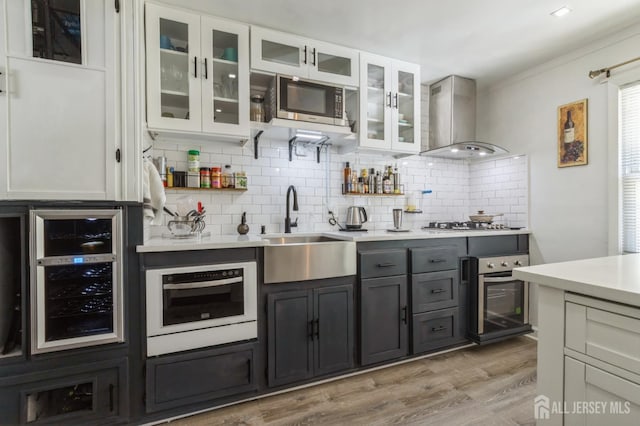 1 Hollywood Dr, Woodbridge Proper, NJ 07095 - kitchen with wall chimney exhaust hood, wine cooler, appliances with stainless steel finishes, a sink, and tasteful backsplash