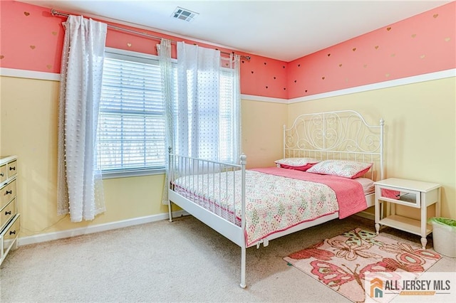 bedroom with visible vents, baseboards, and carpet