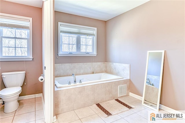 bathroom featuring tile patterned flooring, toilet, visible vents, and plenty of natural light