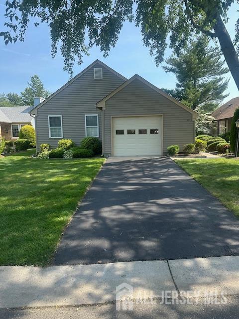 13 Andrew Jackson Ct, Monroe, NJ 08831 - view of front facade featuring driveway, an attached garage, and a front yard