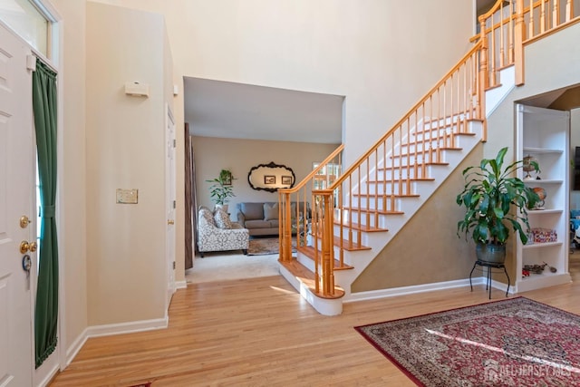 1 Mayfair Ln, Byram, NJ 07821 - entryway featuring baseboards, a high ceiling, stairs, and wood finished floors