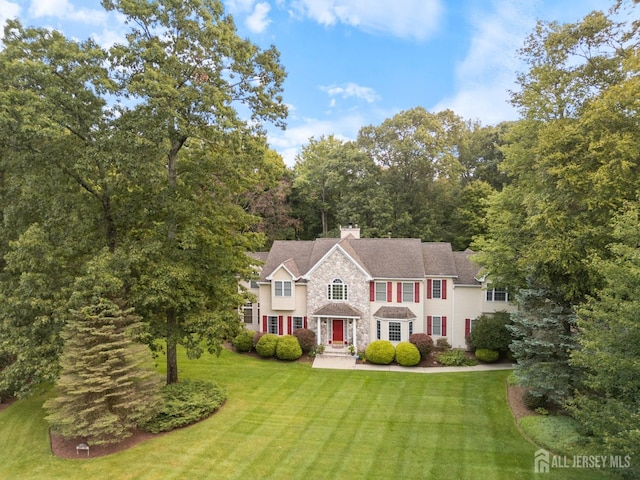 1 Mayfair Ln, Byram, NJ 07821 - view of front of property featuring a chimney, a front lawn, and stone siding