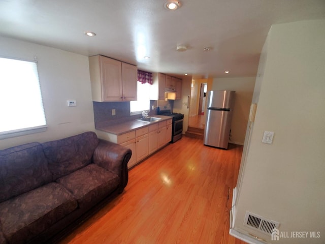 429 Wilfred Ave, Hamilton, NJ 08610 - kitchen featuring appliances with stainless steel finishes, light wood-style floors, light countertops, recessed lighting, and open floor plan