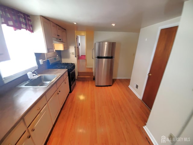 429 Wilfred Ave, Hamilton, NJ 08610 - kitchen featuring freestanding refrigerator, under cabinet range hood, range with gas stovetop, light wood-style flooring, and recessed lighting