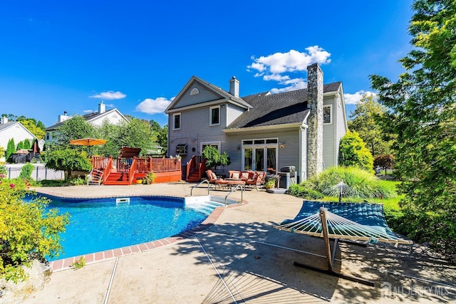 view of swimming pool featuring a deck, fence, and a fenced in pool