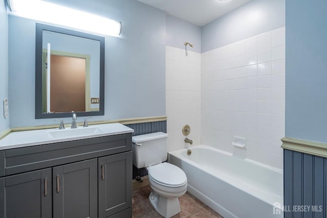 full bath with toilet, washtub / shower combination, vanity, and tile patterned floors