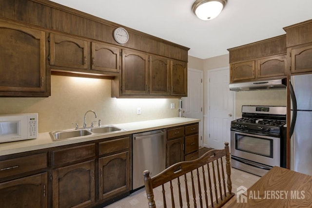 25 Orchard Rd, Middlesex, NJ 08846 - kitchen with appliances with stainless steel finishes, under cabinet range hood, a sink, and light countertops
