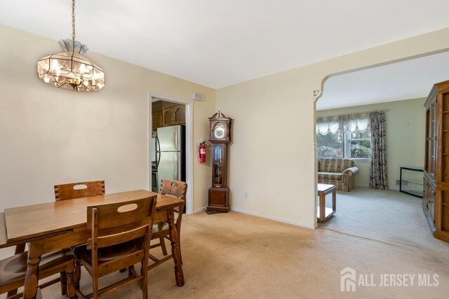 25 Orchard Rd, Middlesex, NJ 08846 - dining space with a chandelier, light carpet, and baseboards