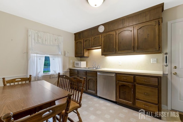 25 Orchard Rd, Middlesex, NJ 08846 - kitchen with stainless steel dishwasher, white microwave, light countertops, a sink, and light floors