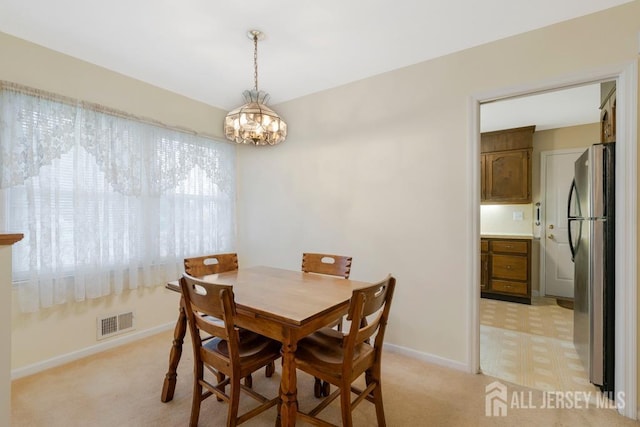 25 Orchard Rd, Middlesex, NJ 08846 - dining area with a chandelier, light carpet, and baseboards