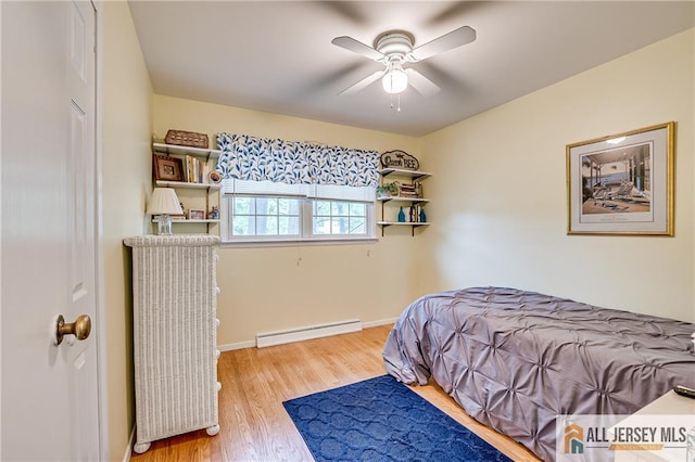 33 Larchmont Rd, Edison, NJ 08837 - bedroom with a baseboard heating unit, wood finished floors, baseboards, and ceiling fan