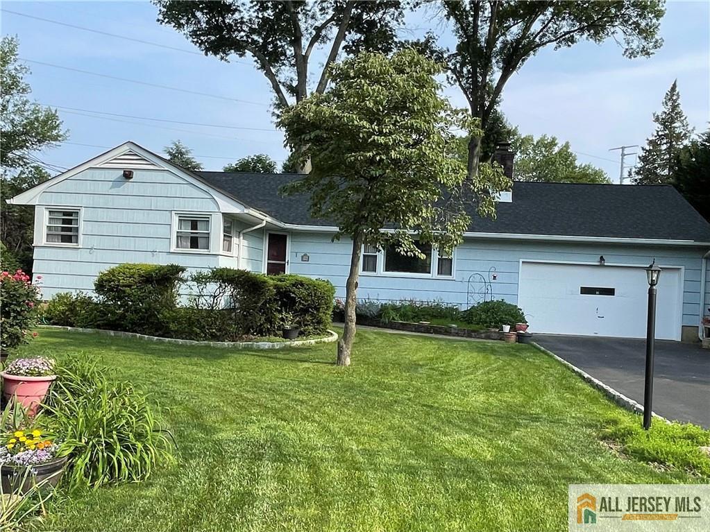 286 Franklin Rd, North Brunswick, NJ 08902 - ranch-style home with asphalt driveway, an attached garage, a front yard, a chimney, and a shingled roof
