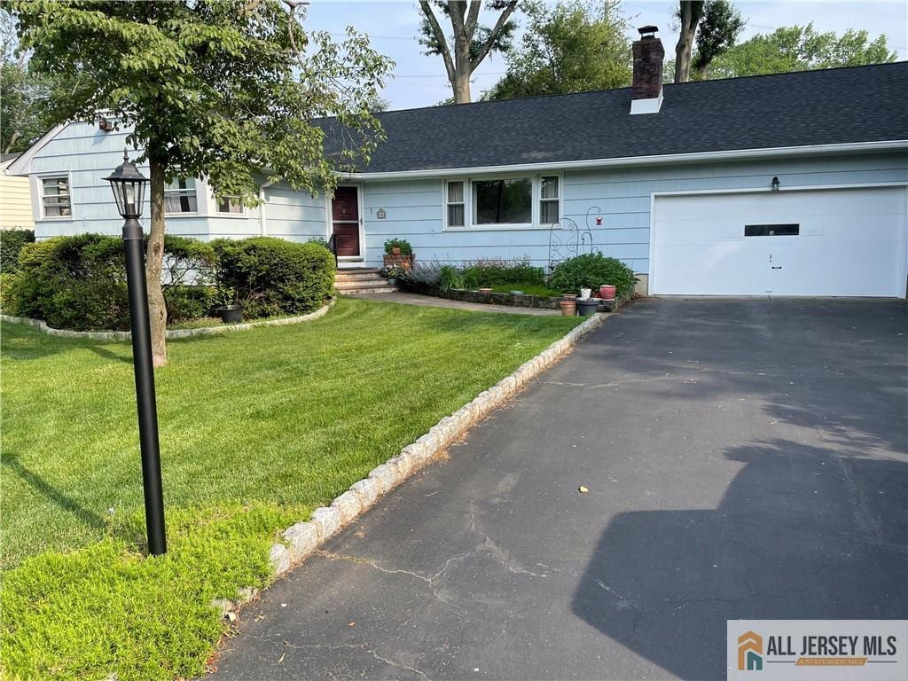 286 Franklin Rd, North Brunswick, NJ 08902 - ranch-style house featuring asphalt driveway, a chimney, a garage, a front lawn, and roof with shingles
