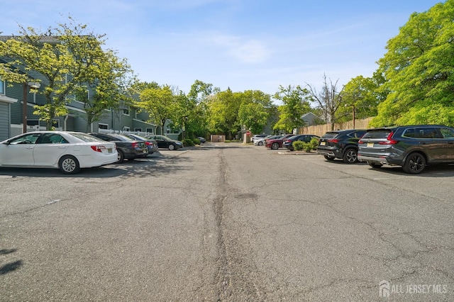 uncovered parking lot featuring a residential view