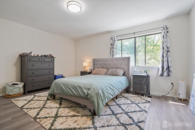 bedroom featuring wood finished floors and baseboards