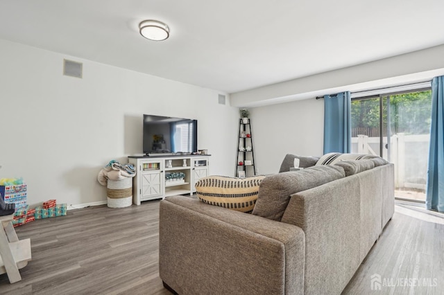 living area featuring wood finished floors and baseboards