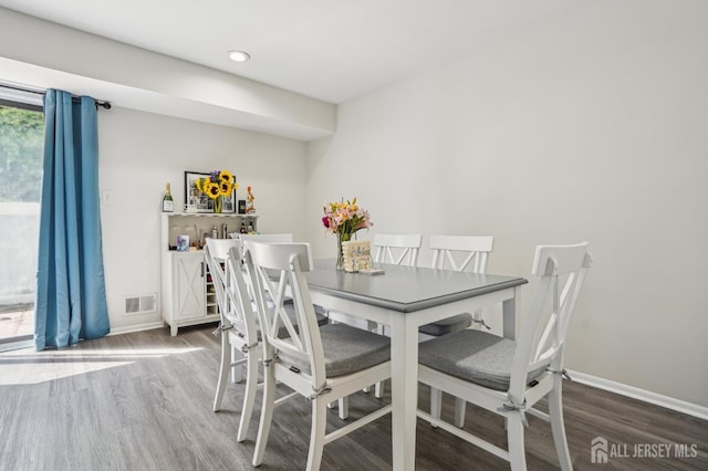 dining area with wood finished floors and baseboards