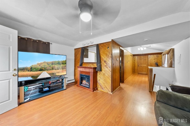 809 Summerfield Ave, South Amboy, NJ 08879 - living area featuring a ceiling fan, wood finished floors, baseboard heating, a glass covered fireplace, and lofted ceiling