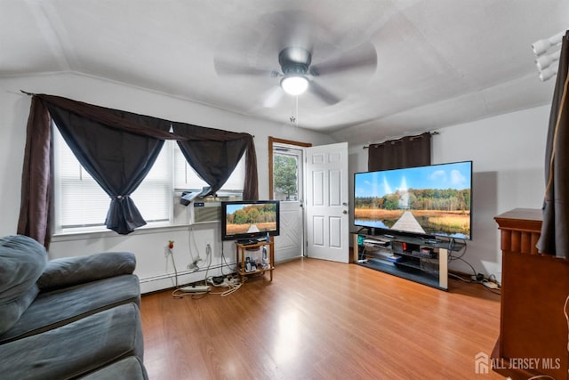 809 Summerfield Ave, South Amboy, NJ 08879 - living area with baseboard heating, a ceiling fan, wood finished floors, and vaulted ceiling