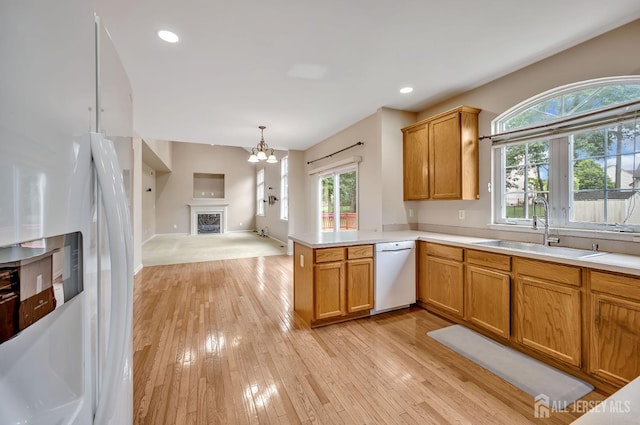27 Rue Chagall, Franklin, NJ 08873 - kitchen with white appliances, a chandelier, light wood finished floors, light countertops, and recessed lighting