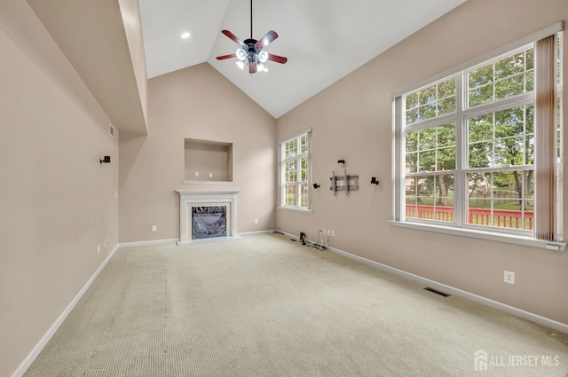 27 Rue Chagall, Franklin, NJ 08873 - unfurnished living room featuring ceiling fan, a fireplace, carpet floors, and high vaulted ceiling