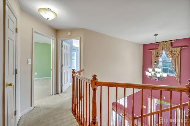 27 Rue Chagall, Franklin, NJ 08873 - hall featuring an upstairs landing, a chandelier, and light colored carpet