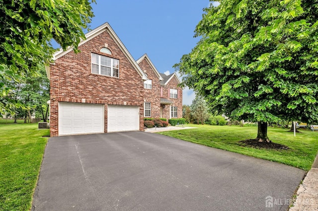 27 Rue Chagall, Franklin, NJ 08873 - traditional home with a garage, driveway, a front lawn, and brick siding