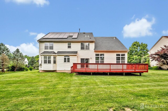 27 Rue Chagall, Franklin, NJ 08873 - back of property with roof mounted solar panels, a yard, and a deck