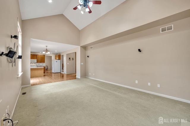 27 Rue Chagall, Franklin, NJ 08873 - unfurnished living room with light carpet, a ceiling fan, a chandelier, high vaulted ceiling, and recessed lighting