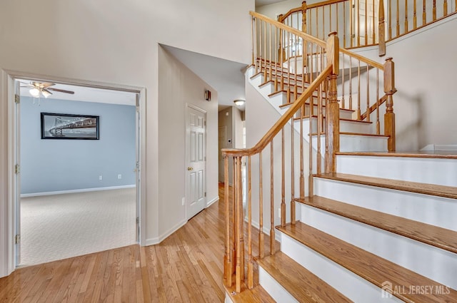 27 Rue Chagall, Franklin, NJ 08873 - stairs with wood finished floors, a ceiling fan, and a towering ceiling